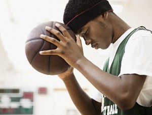 african-american-basketball-player-leaning-head-on-ball-2.jpg