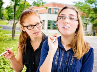 teen girls vaping in high school parking lot