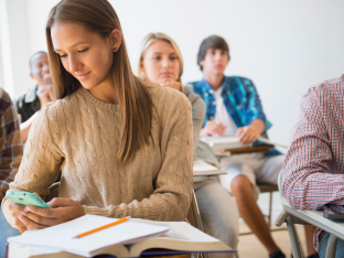 Teen using phone in class