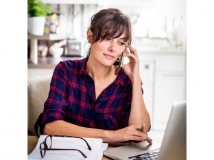 Woman on phone and working on computer