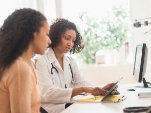 female doctor talking with female patient