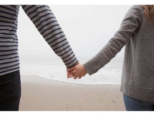 couple holding hands on beach