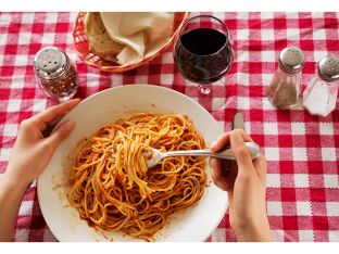 woman eating bowl of pasta