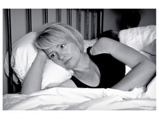 woman lying awake in bed