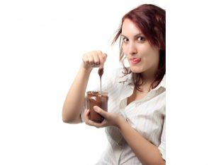 woman eating nutella from a jar