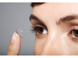 woman putting in contact lens
