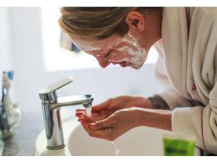 woman washing her face