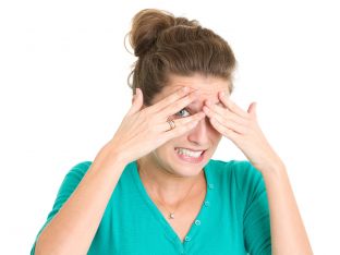 Nervous Young Woman Peeking Through Fingers