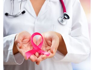 doctor holding pink ribbon for breast cancer awareness
