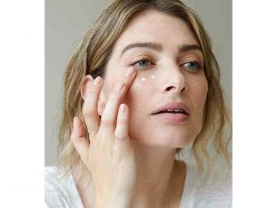 woman applying eye cream