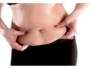woman holding fat on stomach