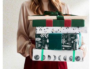 woman with a stack of wrapped christmas presents