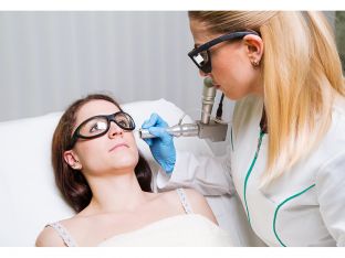 Woman getting facial laser treatment