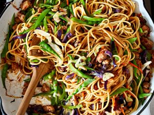 Moo Shu Pork Noodles in bowl with wooden spoon