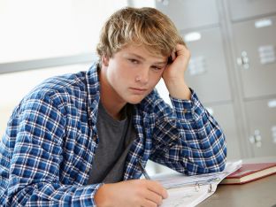 Teen boy looking bored/sleepy in class