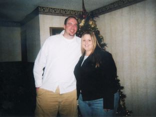 Tiffany Howard BEFORE her weight loss, posing in front of Christmas tree with husband