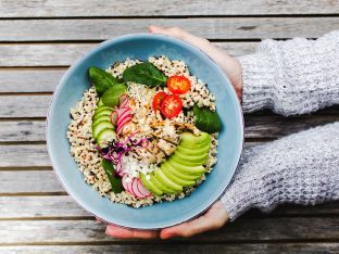woman holding vegetarian salad bowl