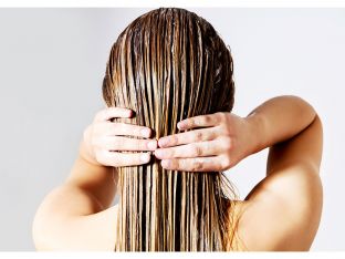 Woman Applying Conditioner On Hair
