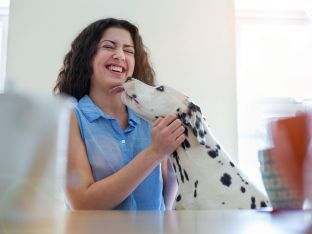 teen girl getting kisses from Dalmatian