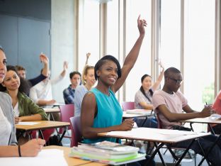 teens raising hand in class