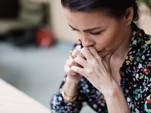 mom of teen looking thoughtful or upset