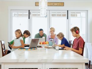 entire family using devices in kitchen