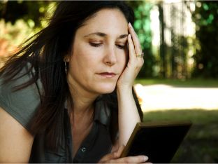 Mom looking at photo in picture frame