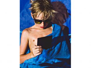 boy reading on amazon kindle paperwhite