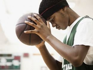 african-american-basketball-player-leaning-head-on-ball-2.jpg