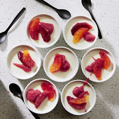 blood oranges and raspberry puree atop vanilla panna cotta