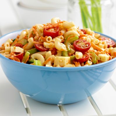 macaroni salad with cherry tomatoes in blue bowl