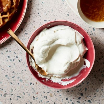 Brown Sugar Whipped Cream in red bowl with spoon