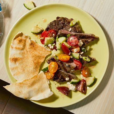 greek steak and salad on plate