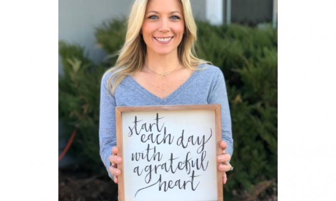 Amy Reinecke Holding Sign
