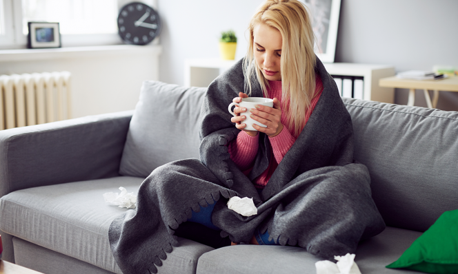 Sick woman drinking tea