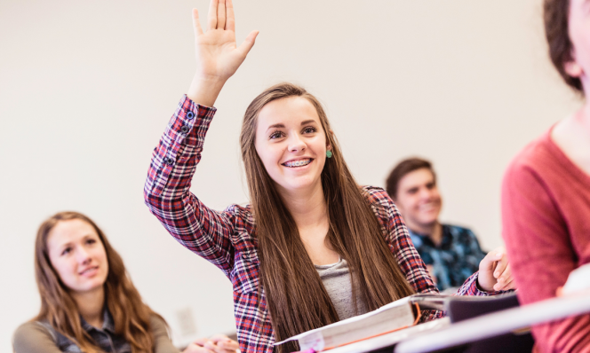 Teen girl participating in class