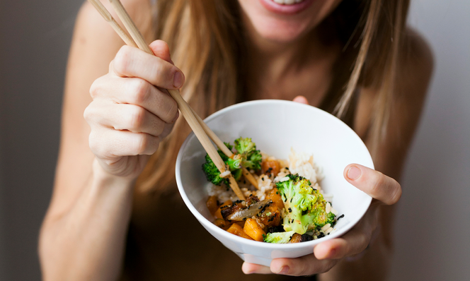 woman eating with chopsticks