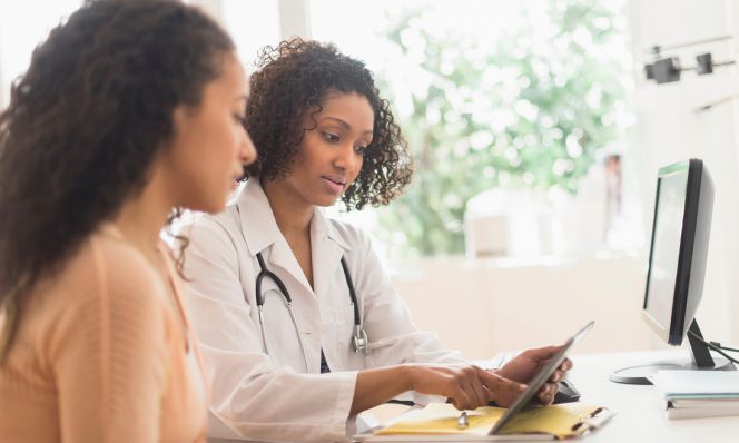 female doctor talking with female patient