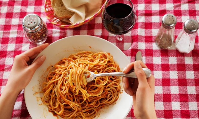 woman eating bowl of pasta