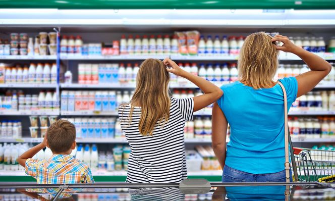 family scratching heads in dairy aisle