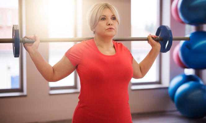 middle-age woman working out in red shirt
