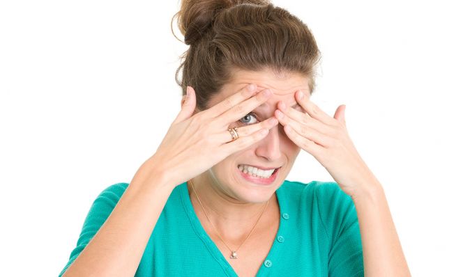 Nervous Young Woman Peeking Through Fingers