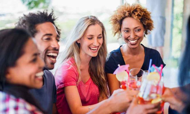 group of adults having cocktails at a party