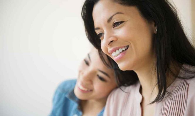 mother and teen daughter smiling together