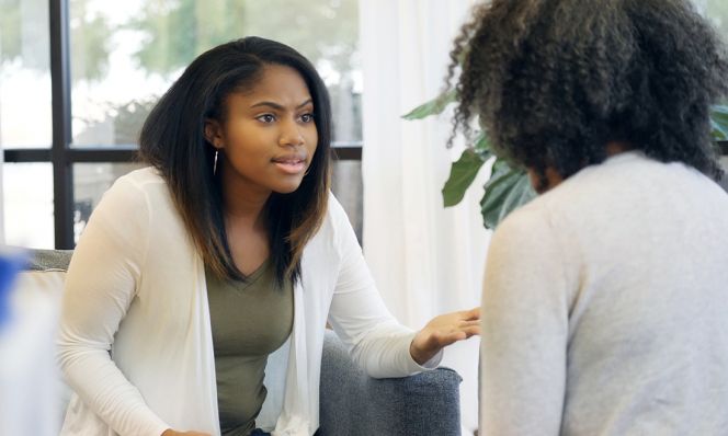 upset teen girl talks with her mom