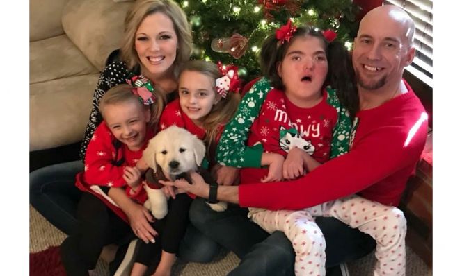 Tiffany Howard AFTER her weight loss, with family by Christmas tree