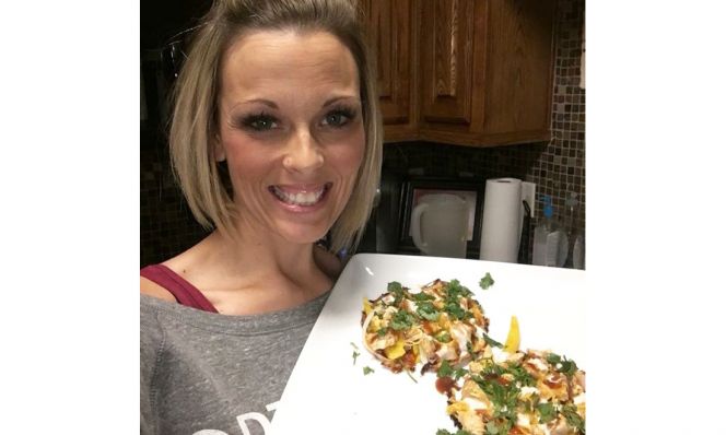 Tiffany Howard AFTER her weight loss, posing with healthy meal