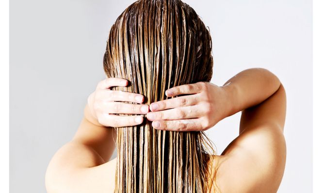Woman Applying Conditioner On Hair