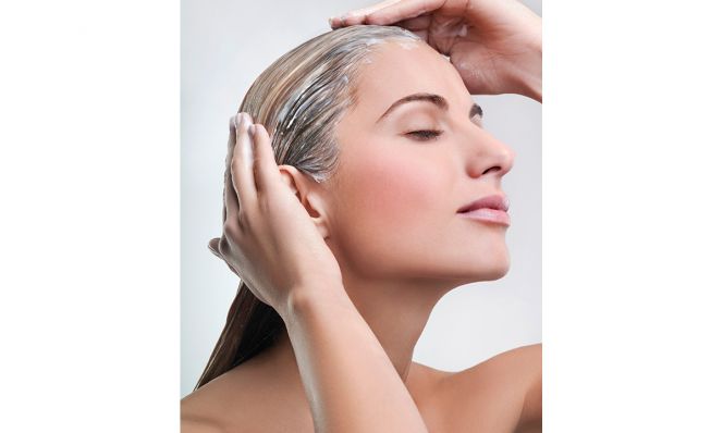 Woman applying hair mask