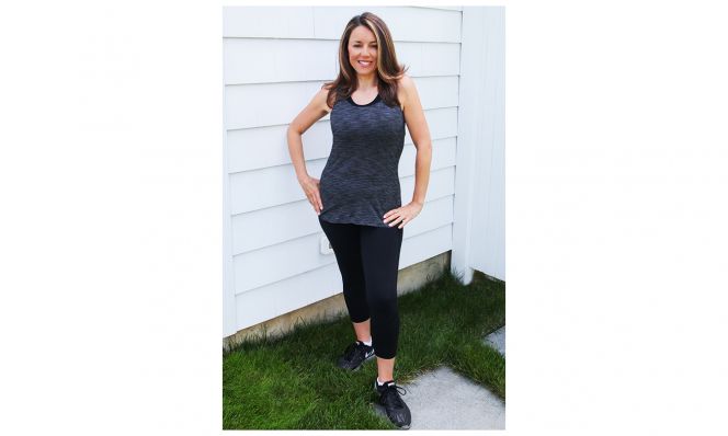 Amy Ruggiero, after her weight loss, poses in workout attire